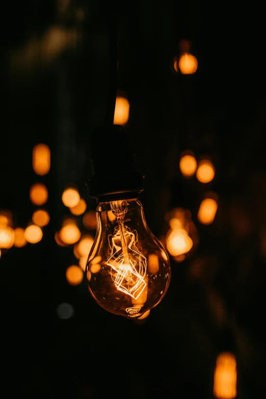 a light bulb hanging from a string of lights, by Jesper Knudsen, pexels, light and space, screensaver, gnarly details soft light, instagram post, during the night