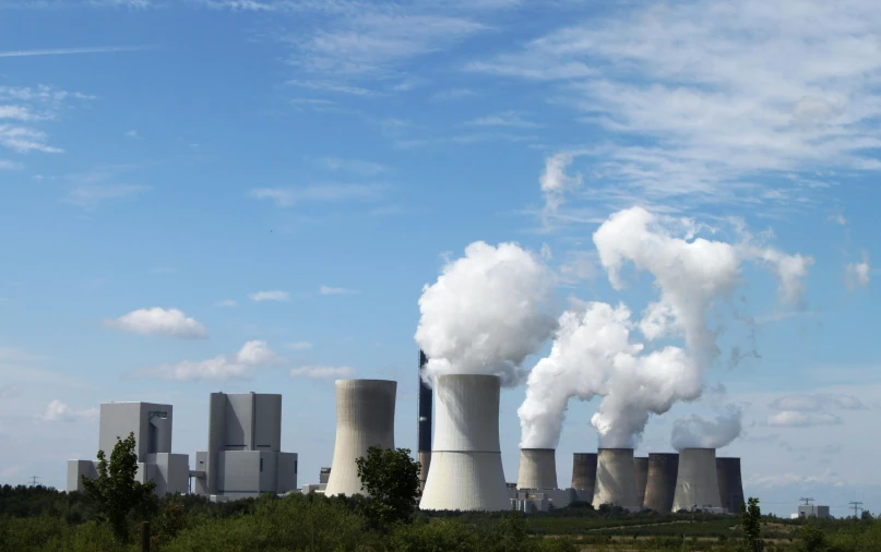 a factory with a lot of smoke coming out of it, by Werner Gutzeit, pexels contest winner, renaissance, two giant towers, large blue engines, 2022 photograph, a green