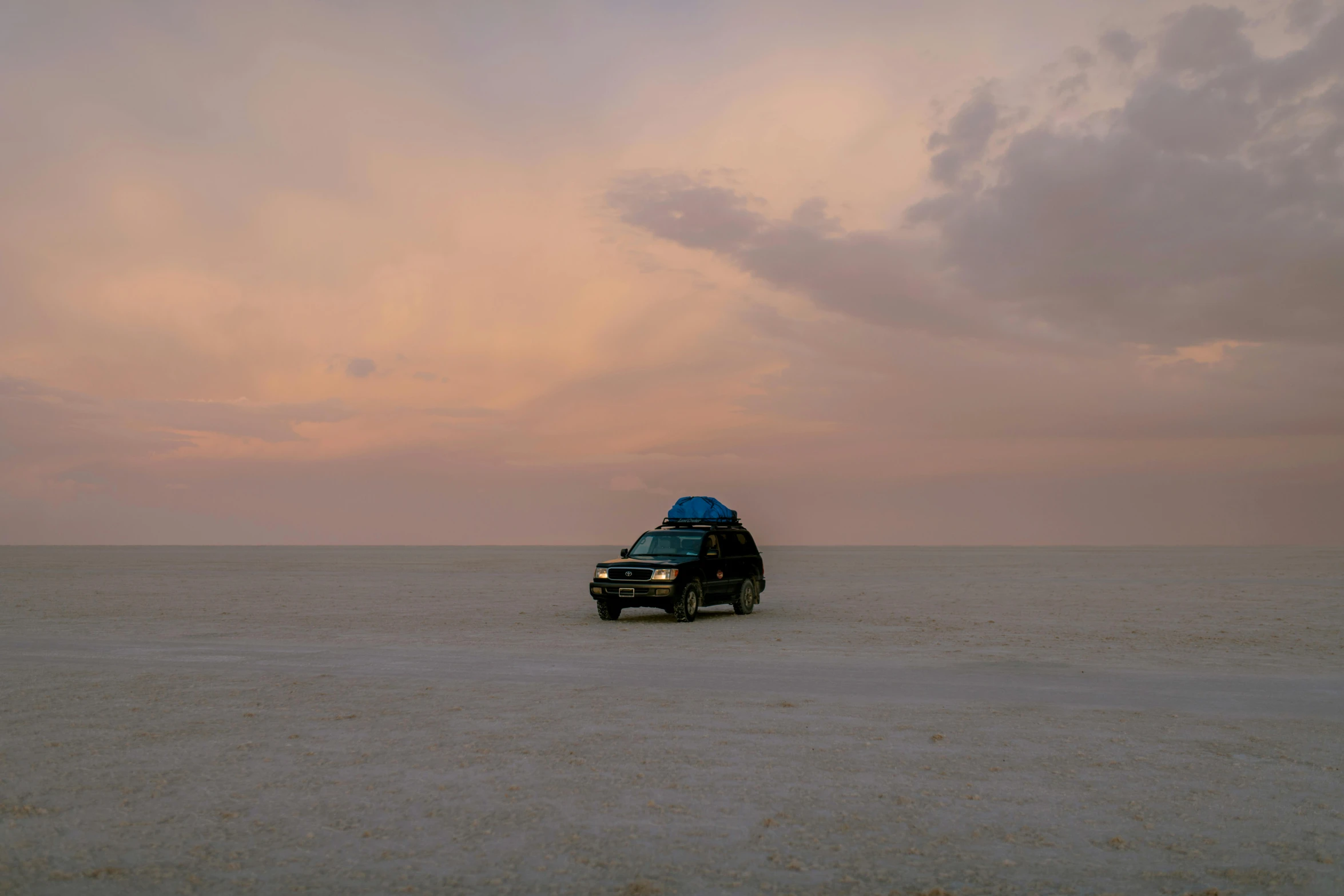 a car that is sitting in the sand, by Jessie Algie, unsplash contest winner, romanticism, epic wide sky and horzon, square, lada, covered in salt