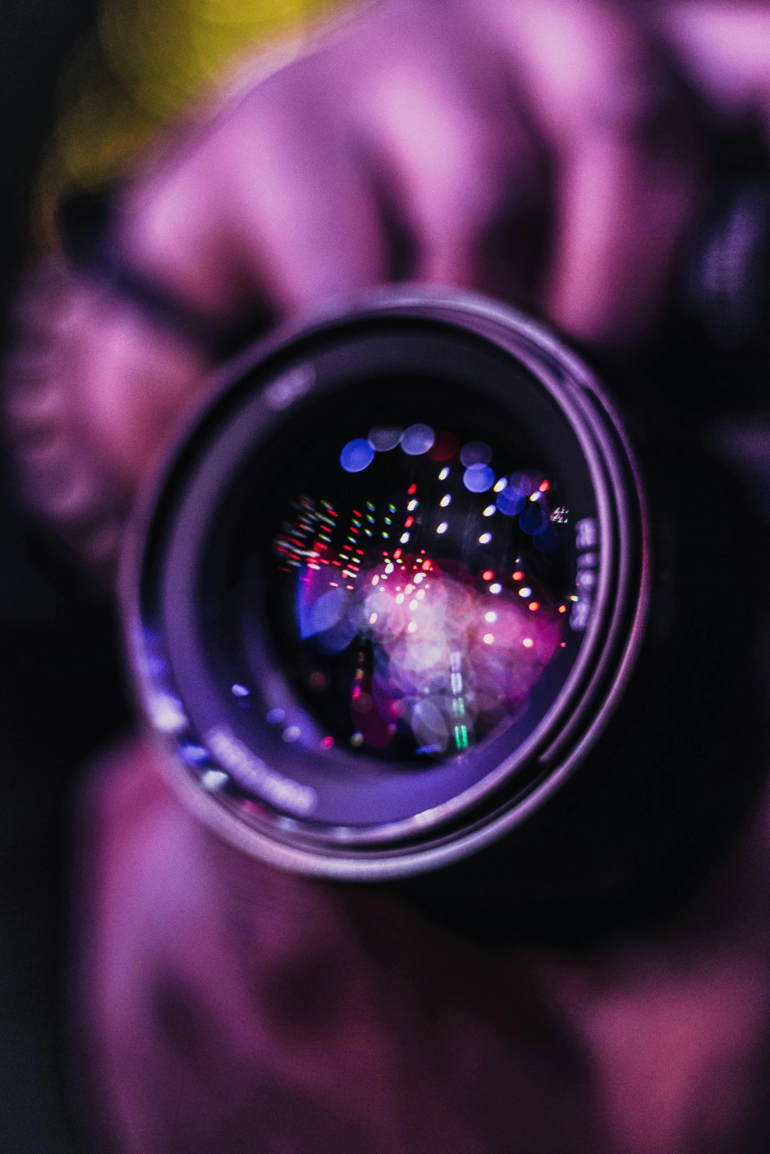 a close up of a person holding a camera, pexels contest winner, art photography, holographic display lenses, purple filter, macro lense, bokeh. i