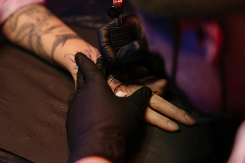 a man getting a tattoo on his arm, a tattoo, by Adam Marczyński, trending on pexels, neon ink, thumbnail, black nails, warm shading