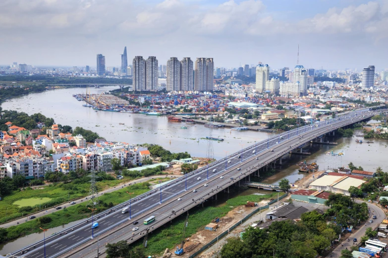 a bridge over a river with a city in the background, pexels contest winner, hyperrealism, vietnam, high rise buildings, slide show, koyaanisqatsi