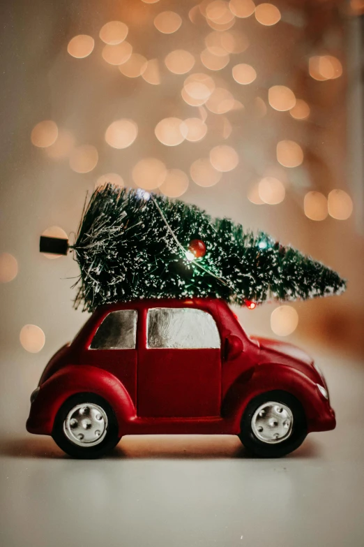 a toy car with a christmas tree on top of it, a photo, by Elaine Hamilton, pexels contest winner, folk art, carpool karaoke, dressed in a beautiful, postprocessed, closeup of an adorable