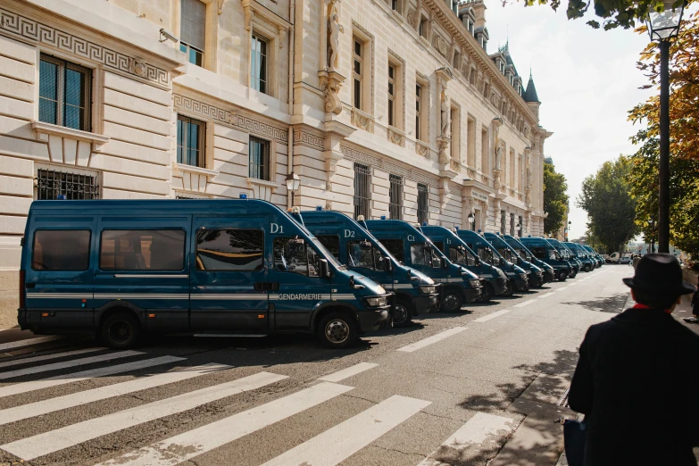 a row of blue vans parked on the side of a street, by Raphaël Collin, private press, musee d'orsay 8 k, neoclassical police station, thumbnail, dezeen