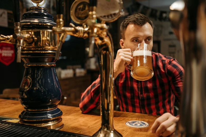 a man sitting at a bar drinking a beer, pexels contest winner, renaissance, aussie baristas, shepherd's crook, beers on the table, 1 2 9 7