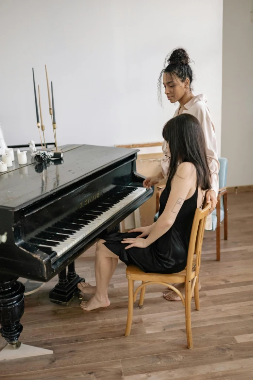 a man and a woman sitting at a piano, trending on pexels, asian women, sitting on a chair, standing, plain