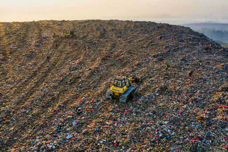 a bulldozer sitting on top of a pile of garbage, by Daniel Lieske, reddit, drone wide shot, instagram photo, contain, an ancient