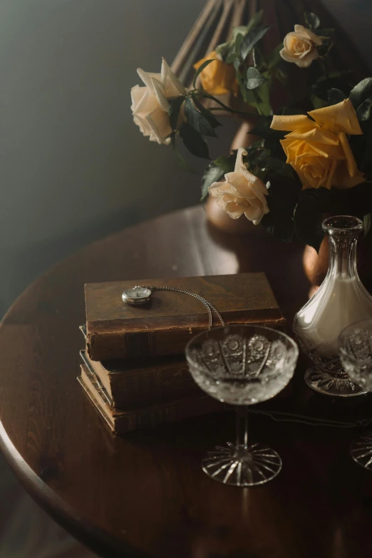 a wooden table topped with a vase filled with flowers, a still life, inspired by Allan Ramsay, trending on unsplash, romanticism, books covered in jewels, 1 9 2 0's style speakeasy, low lighting, dusty library