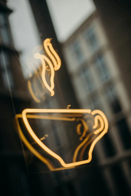 a close up of a cup of coffee on a window sill, by Adam Marczyński, pexels contest winner, graffiti, gold light, neon electronic signs, soft outline, digital image