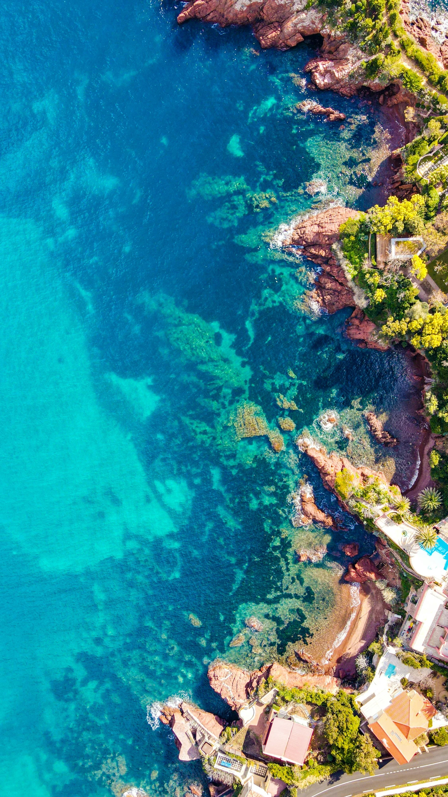 a large body of water next to a beach, a screenshot, pexels, monaco, aerial photo, lush surroundings, intense colours