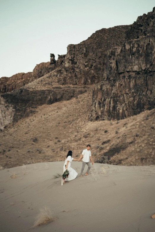 a couple of people that are walking in the sand, over a cliff, idaho, cute photo, shot from cinematic