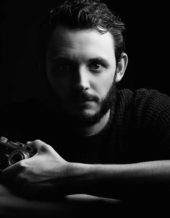 a black and white photo of a man holding a gun, a black and white photo, inspired by Peter Basch, unsplash contest winner, portrait of tom holland, color photograph portrait 4k, chiaroscuro!!, cinematic. by leng jun