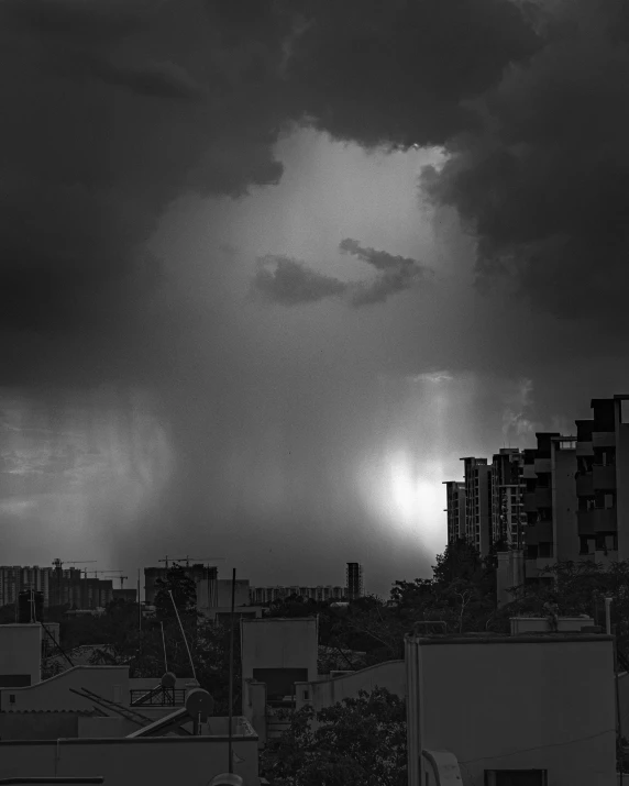 a black and white photo of a cloudy sky, by Jan Rustem, bangalore, lightning and rain, ilustration, urban