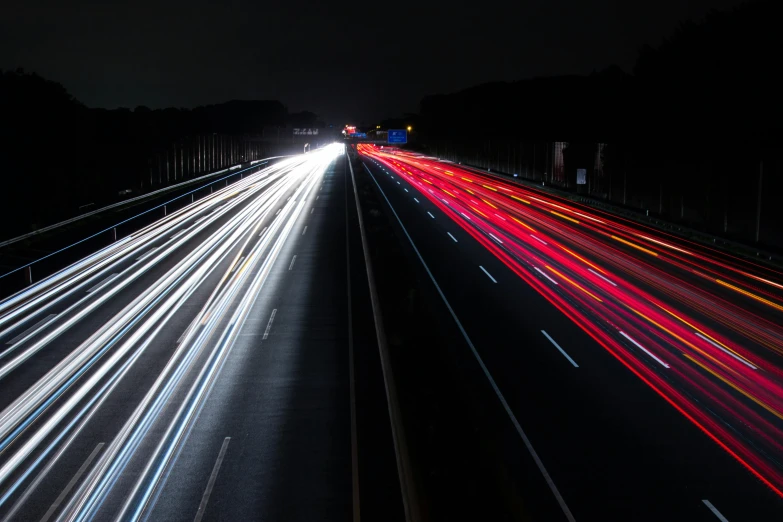 a highway filled with lots of traffic at night, unsplash, photorealism, high speed shutter, thumbnail, cinematic shot ar 9:16 -n 6 -g, red and white lighting