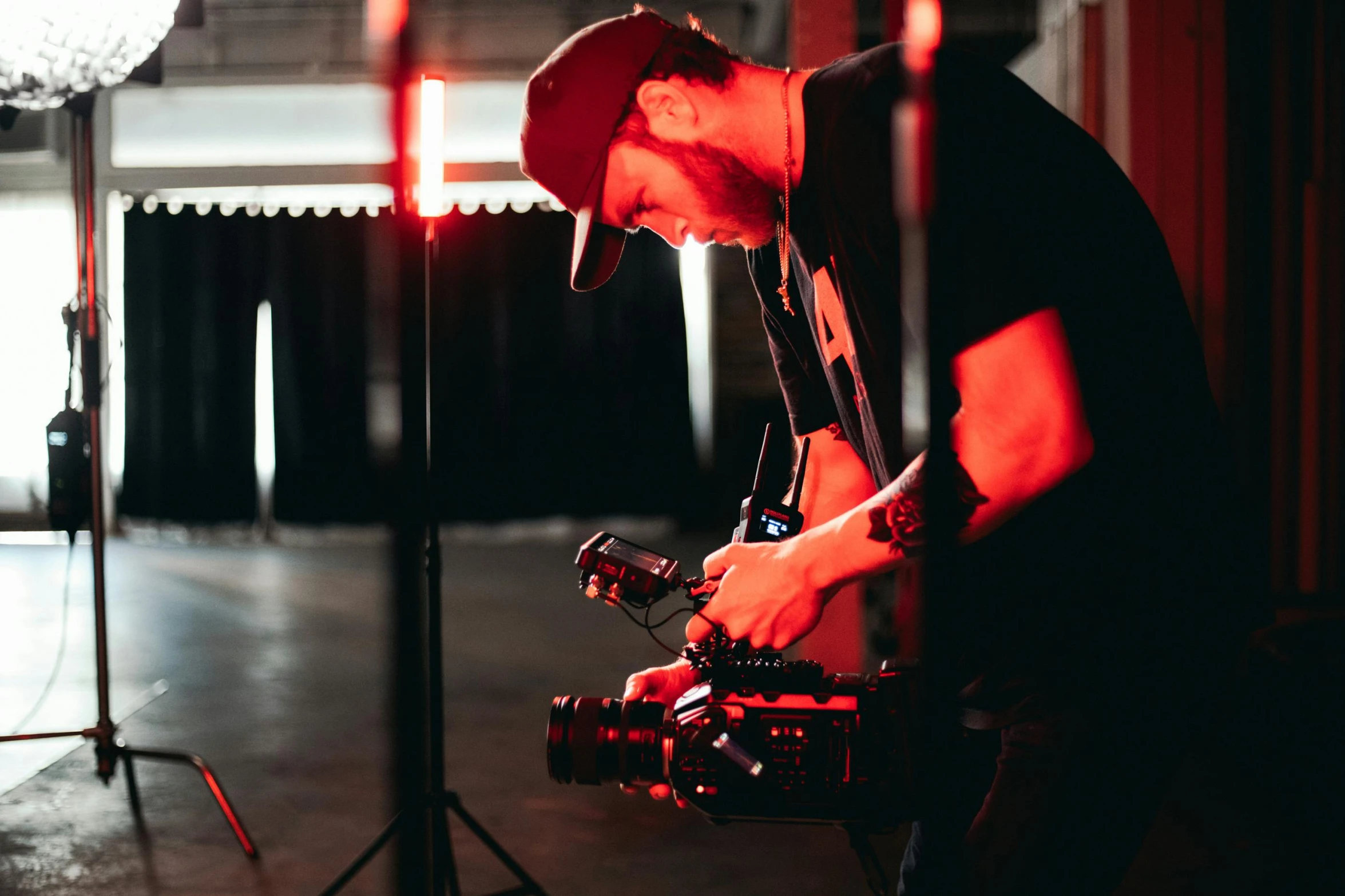 a man that is standing in front of a camera, a picture, performing a music video, red camera, inspect in inventory image, cinematic lighting photography