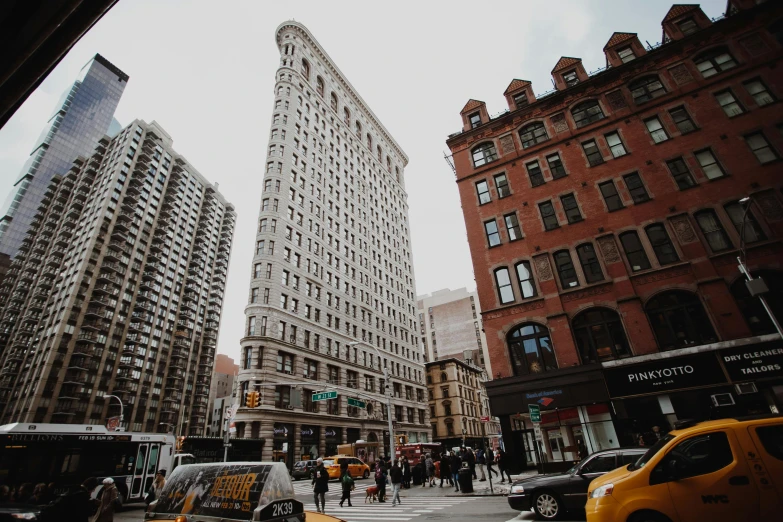 a city street filled with lots of traffic and tall buildings, a photo, pexels contest winner, art nouveau, new york buildings, square, ad image