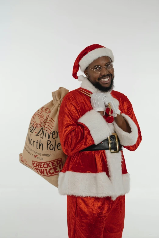 a man dressed as santa claus holding a sack of presents, an album cover, pexels, hurufiyya, african aaron paul, official government photo, ray lewis, profile pic