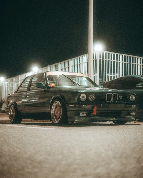 a couple of cars parked next to each other, by Adam Rex, pexels contest winner, renaissance, bmw e 3 0, dark green tint, during night, 🚿🗝📝