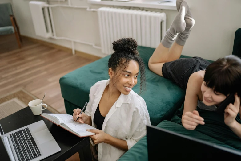 a couple of women sitting on top of a green couch, a picture, trending on pexels, sitting at a computer desk, thighs focus, sydney park, college students