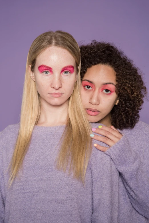 two women standing next to each other in front of a purple background, trending on pexels, renaissance, rainbow eyes, red contact lenses, promo image, freckles on chicks