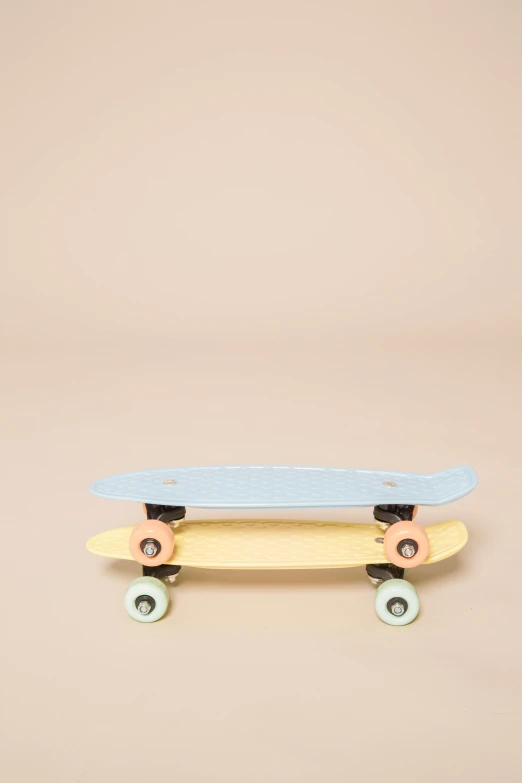 a skateboard sitting on top of a wooden table, cream, mini model, pastel', two - tone