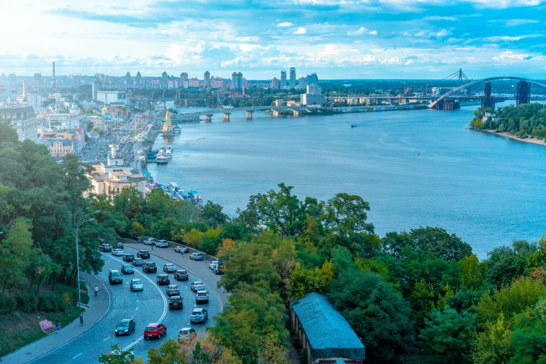 a view of a city from the top of a hill, a photo, ukrainian flag on the left side, thumbnail, coastline, khreschatyk