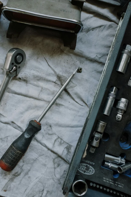 a bunch of tools sitting on top of a table, sweating, high quality product image”, underbody, faded worn