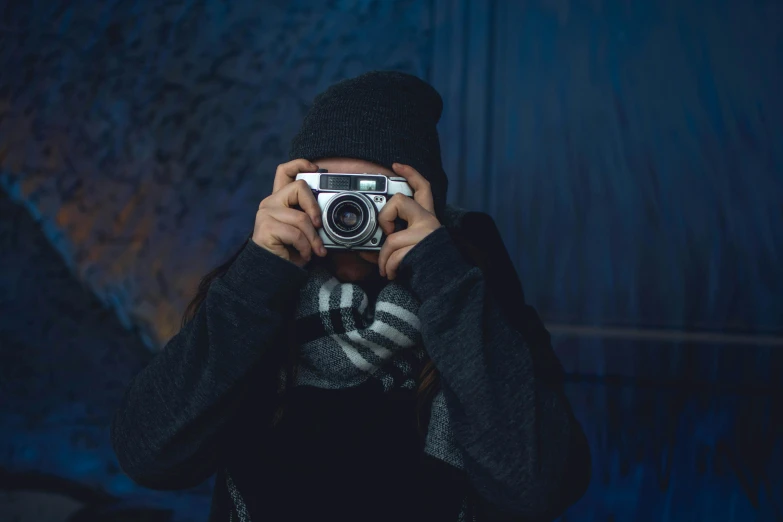 a person taking a picture with a camera, inspired by Elsa Bleda, dark backround, medium format, picture, spying