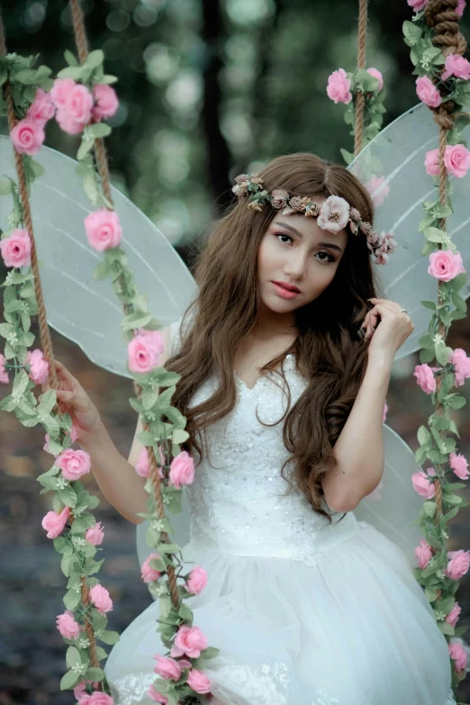 a girl in a white dress is sitting on a swing, by Marie Angel, pixabay contest winner, portrait of very beautiful elf, ulzzang, flower tiara, 256435456k film