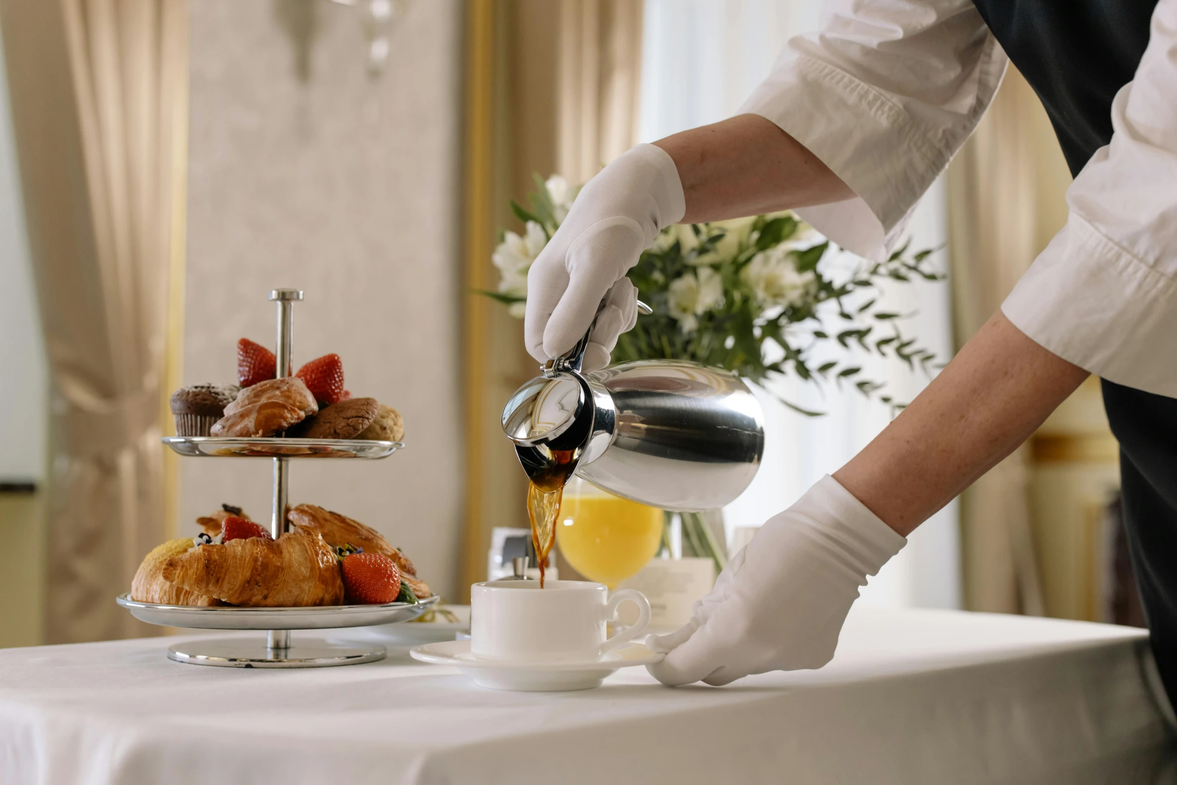 a person in white gloves pouring tea into a cup, a still life, inspired by Richmond Barthé, pexels contest winner, breakfast buffet, hotel room, palatial scene, plated arm