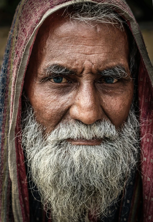a close up of a person with a long beard, a character portrait, inspired by Steve McCurry, pexels contest winner, square masculine facial features, wise old indian guru, a photo of a disheveled man, 5 0 0 px models