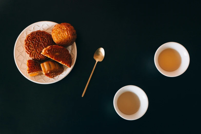 a plate of cookies and two cups of tea, a still life, by Shang Xi, trending on unsplash, square, chinatown, caramel, intricately carved