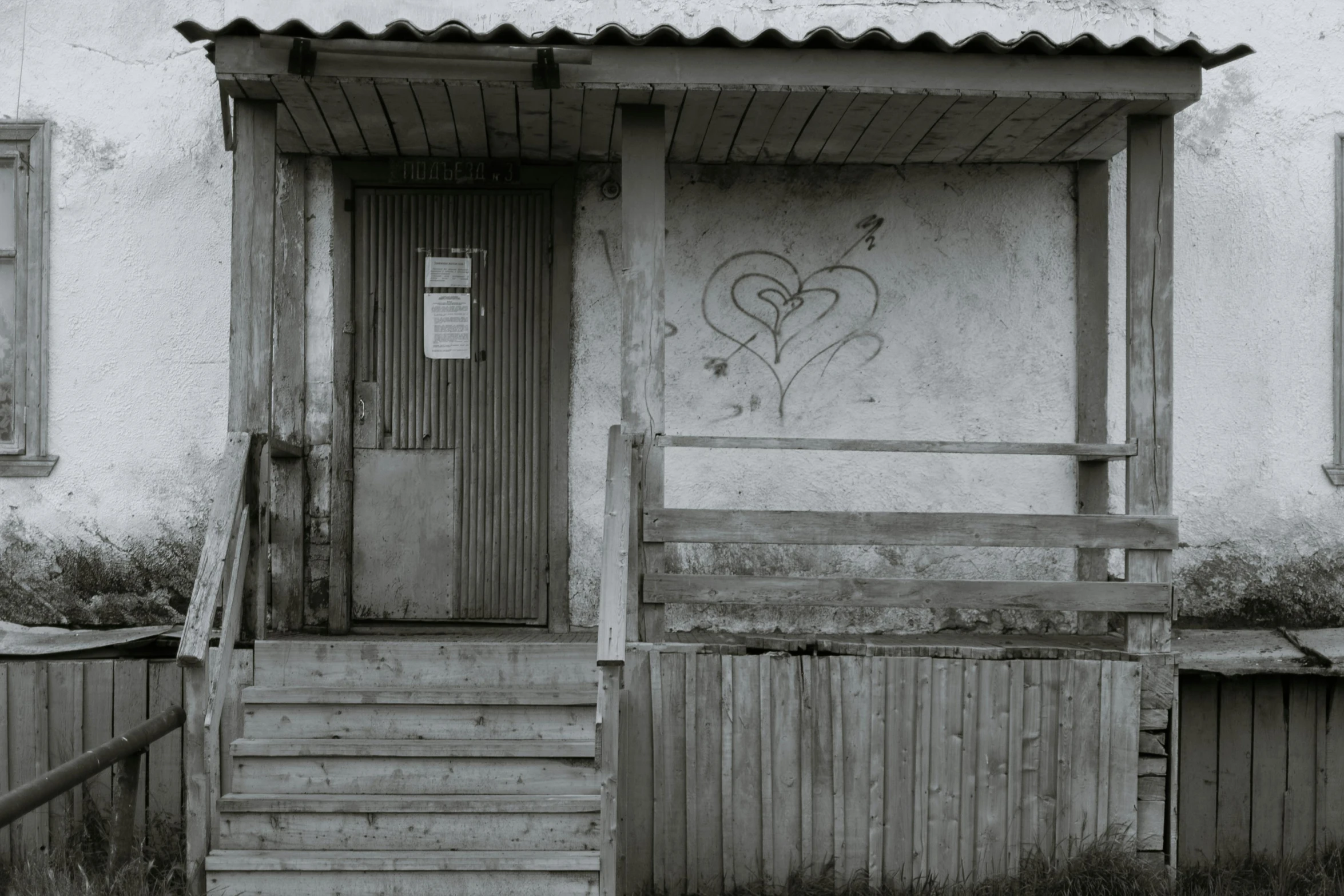 a black and white photo of a house with graffiti on it, pexels contest winner, graffiti, hearts, stood outside a wooden cabin, steps, bleak