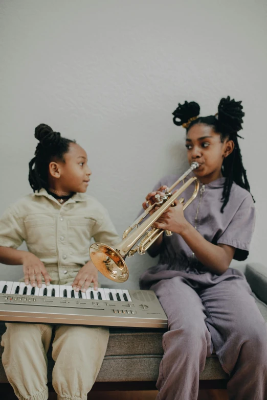 a boy and a girl playing a musical instrument, pexels contest winner, black arts movement, willow smith young, brass equipment and computers, annoying sister vibes, in real life