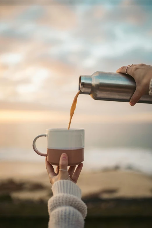 a person pouring a cup of coffee into a mug, pexels contest winner, ocean view, manuka, light tan, flasks