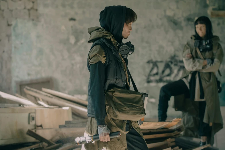 a couple of people standing next to each other, unsplash, renaissance, carrying survival gear, action shot girl in parka, production still, model is wearing techtical vest