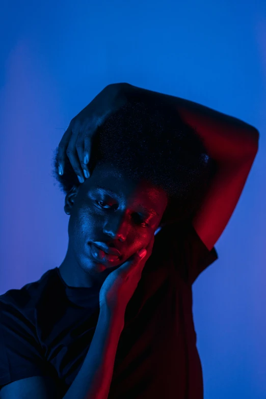 a man talking on a cell phone in a dark room, an album cover, by Cosmo Alexander, pexels contest winner, black young woman, red and blue black light, portrait androgynous girl, relaxed pose