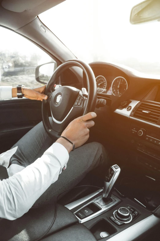 a man sitting in the driver's seat of a car, trending on unsplash, bmw, low quality photo, cruise control, thumbnail