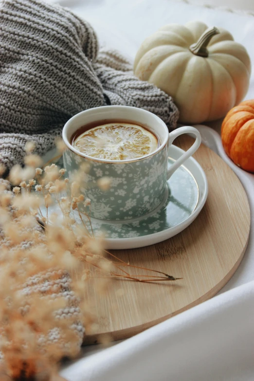 a cup of coffee sitting on top of a wooden tray, by Carey Morris, autumnal, thumbnail, sage, soup