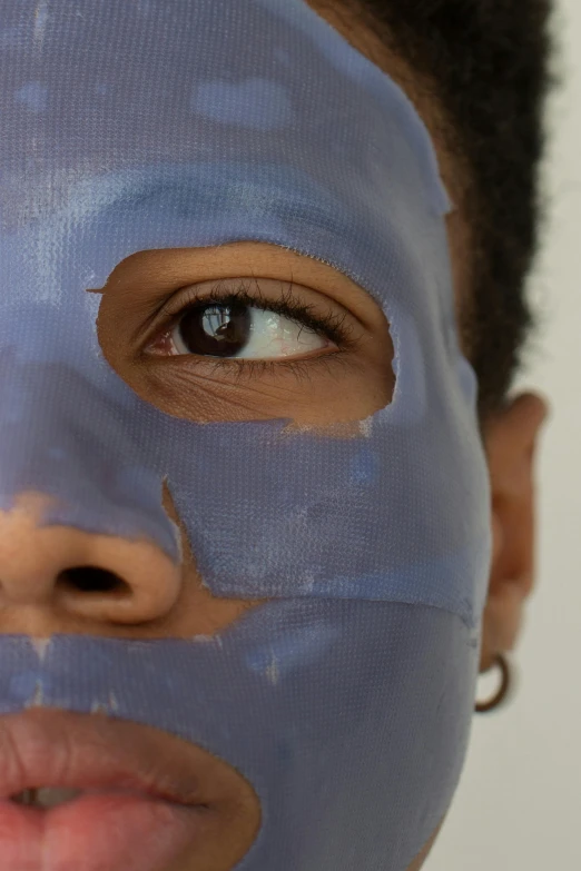 a close up of a person with a face mask, inspired by Marina Abramović, lupita nyong'o, smooth blue skin, hyperrealistic”