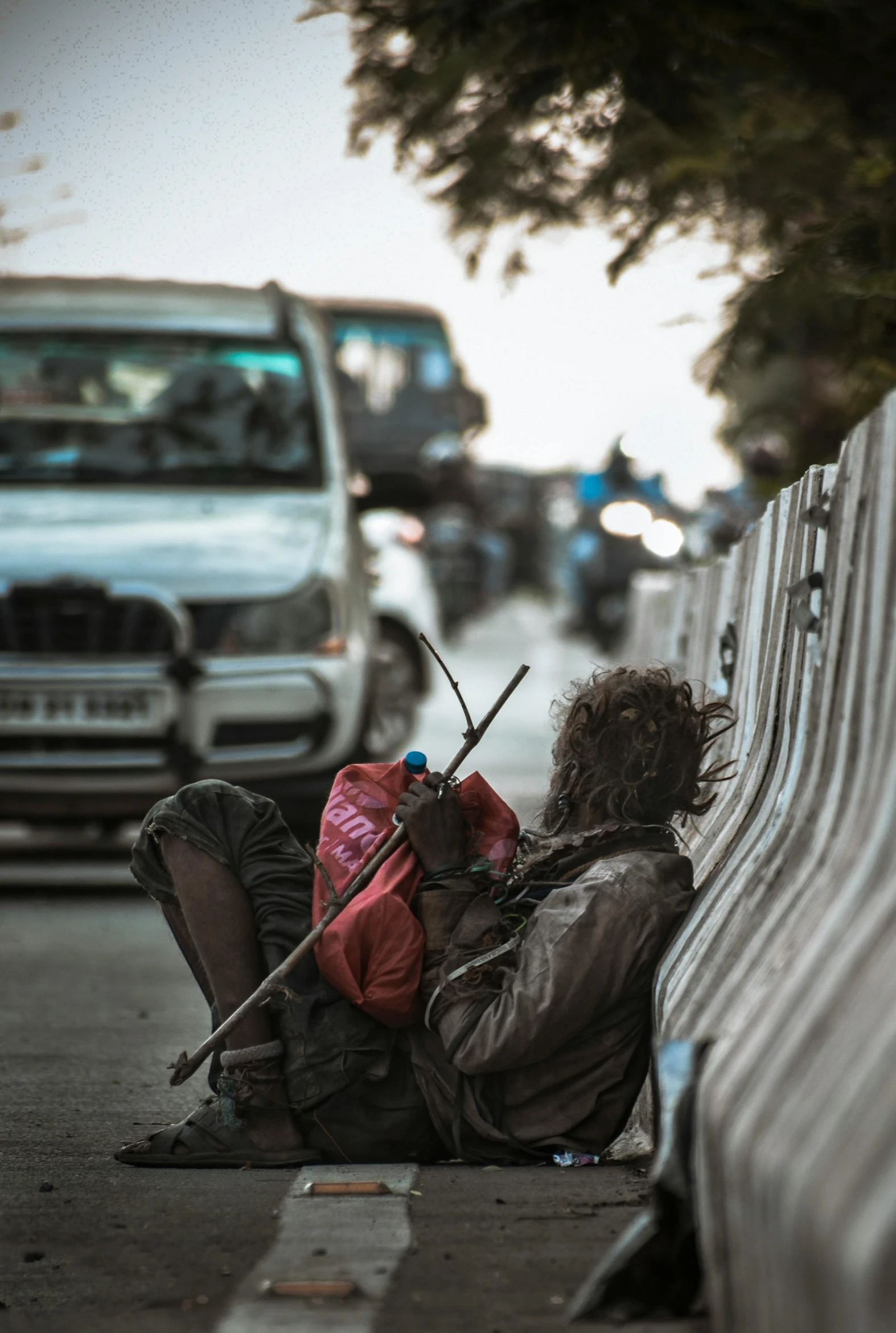 a homeless person sitting on the side of the road, pexels contest winner, happening, sri lankan mad max style, busy streets, a person at a music festival, postapocalyptic