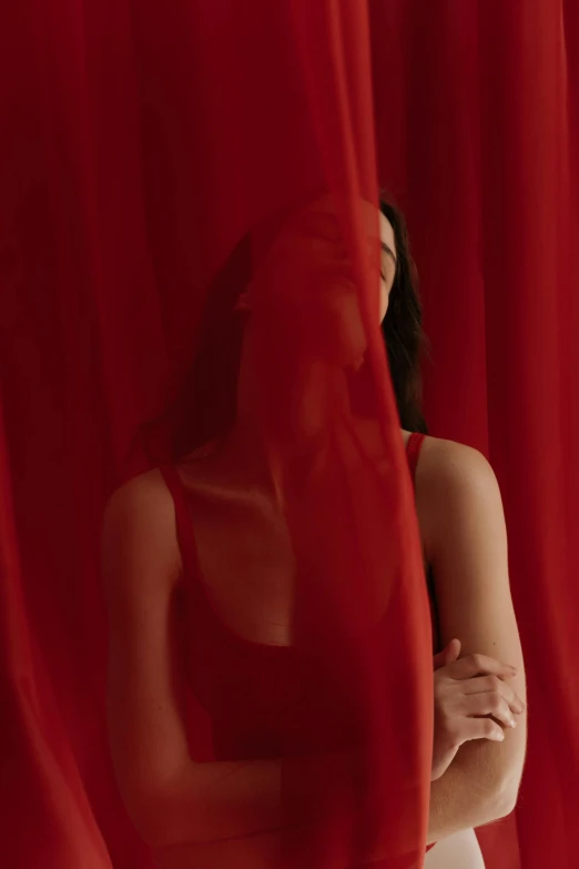 a woman standing in front of a red curtain, showstudio, bella poarch, **cinematic, multiple stories