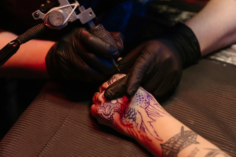 a person getting a tattoo on another person's arm, pexels contest winner, neon ink, aaron horkey, amanda lilleston, gloves and jewelry. motion