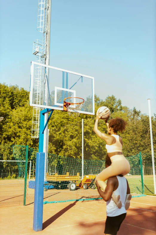 a man and a woman playing basketball on a court, an album cover, by Lee Gatch, trending on dribble, doja cat, giantess, at a park, sport bra and shorts