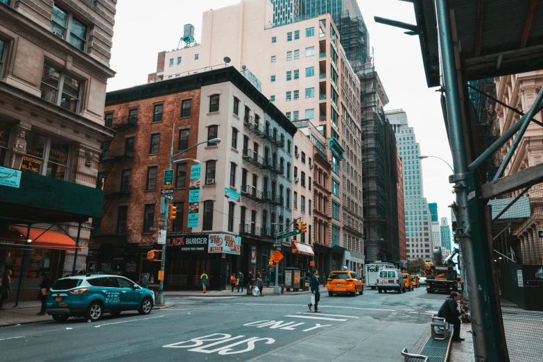 a city street filled with lots of traffic and tall buildings, a photo, pexels contest winner, new york back street, street of teal stone, background image, street corner