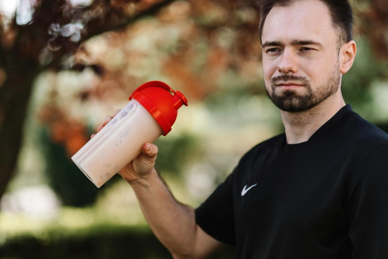 a man holding a protein shake in his hand, a portrait, by Adam Marczyński, pexels contest winner, ricky berwick, avatar image, outdoor photo, profile picture