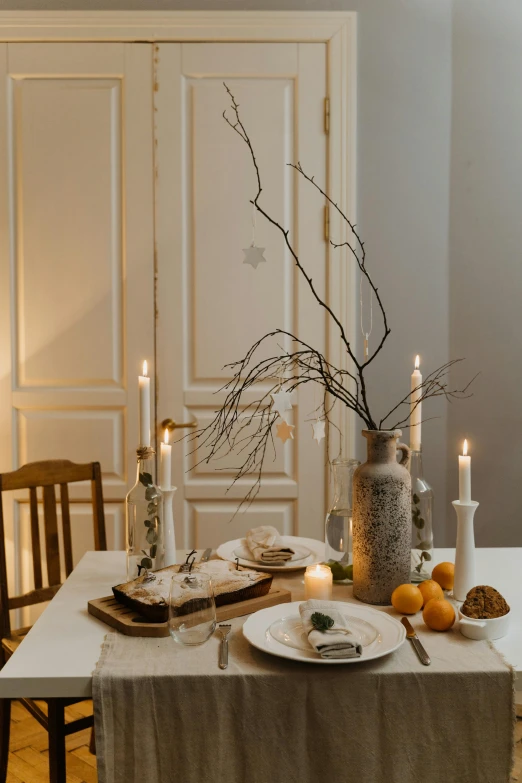 a table that has a bunch of plates on it, by Zofia Stryjenska, pexels contest winner, baroque, natural candle lighting, soft light of winter, tall, on white