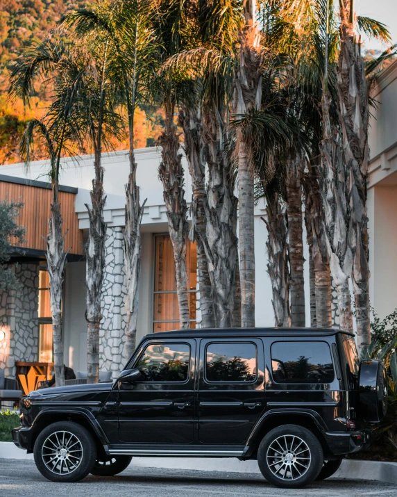 a black jeep parked in front of a building, unsplash, renaissance, malibu canyon, profile image, multiple stories, palm springs