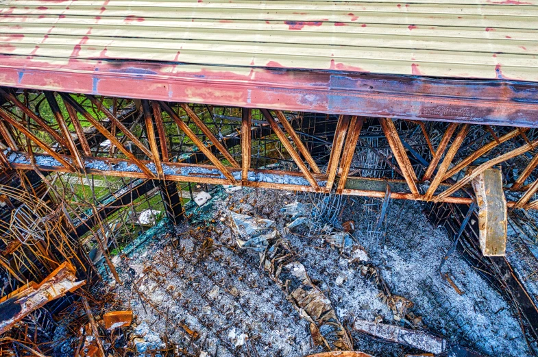 a close up of a train bridge over a body of water, auto-destructive art, drone photo, collapsed floors, thumbnail, brown