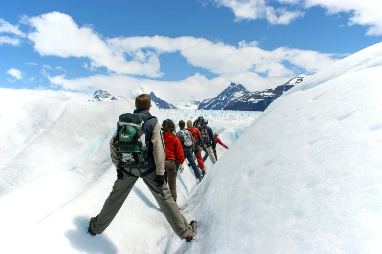 a group of people walking across a snow covered slope, pexels contest winner, blue glacier, thumbnail, chilean, head down